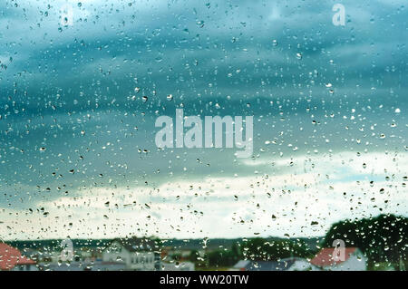 rain and clouds outside the window, raindrops on the window Stock Photo