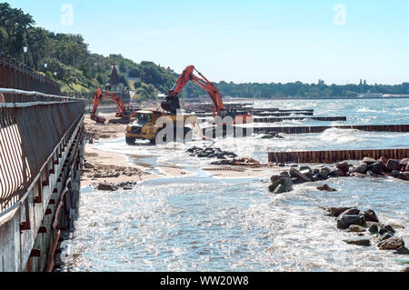 construction equipment on the seashore, construction of breakwaters in the Baltic sea, Baltic sea, Kaliningrad region, Russia, July 15, 2018 Stock Photo