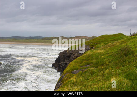 Stormy seas break on the rocks and the bay at Bundoran on the Atlantic coast in the North West of Ireland Stock Photo