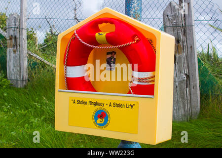 22 August 2019 A red lifebuoy in a yellow high impact plastic housing on a cliff path in Bundoran Donegal Stock Photo