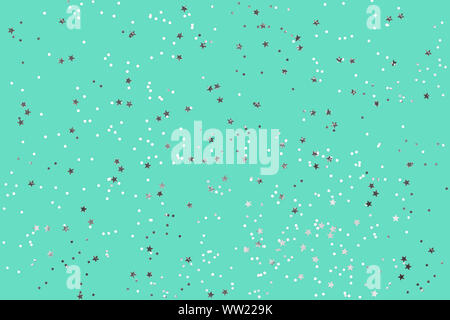 Green mint background with silver glitter and metallic stars. Flat lay style Stock Photo