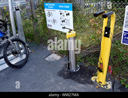 Maidstone, Kent, UK. Bike repair stand and tyre pump on the platform of Maidstone East railway station Stock Photo