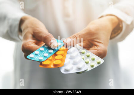 pharmacy - woman hands holding blister packs with pills Stock Photo