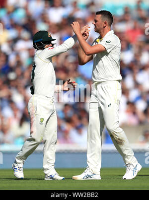 Australia's Josh Hazlewood (right) celebrates the wicket of England's Rory Burns with team mates during day one of the fifth test match at The Oval, London. Stock Photo