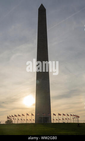 Washington Monument is silhouetted by the late afternoon sun on the National Mall in Washington, DC.