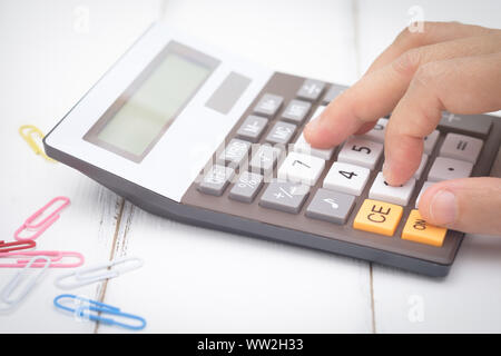 businesswoman using a calculator on desk, Choose focus point. Stock Photo
