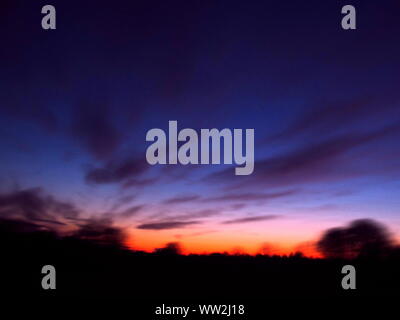 sunrise in red and blue, blurred landscape, abstract background Stock Photo