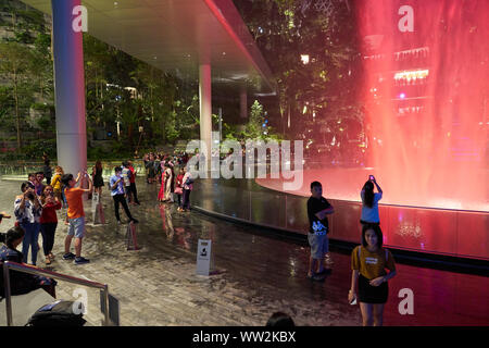SINGAPORE - CIRCA APRIL, 2019: 40-meter HSBC Rain Vortex, the world’s tallest indoor waterfall at the Jewel Changi Airport at night. Stock Photo