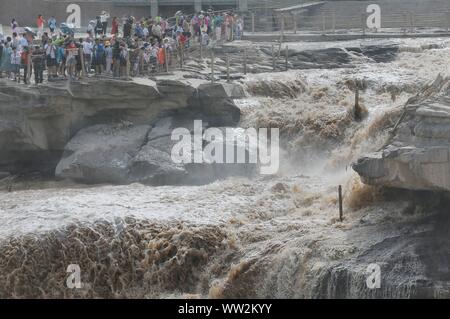 Tourists view the Hukou Waterfall on the Yellow River, also known as Huanghe, in Jixian County, Linfen City, north China's Shanxi Province on August 1 Stock Photo