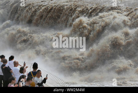 Tourists view the Hukou Waterfall on the Yellow River, also known as Huanghe, in Jixian County, Linfen City, north China's Shanxi Province on August 1 Stock Photo