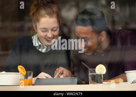 Couple sitting in restaurant Stock Photo