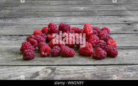 Fresh raspberries on old , rustic, wooden table. Stock Photo