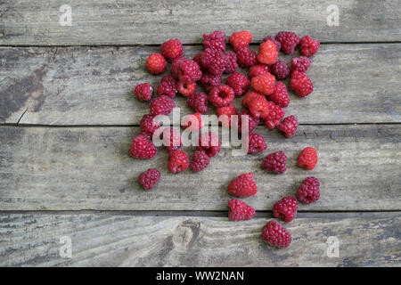 Fresh raspberries on old , rustic, wooden table. Stock Photo
