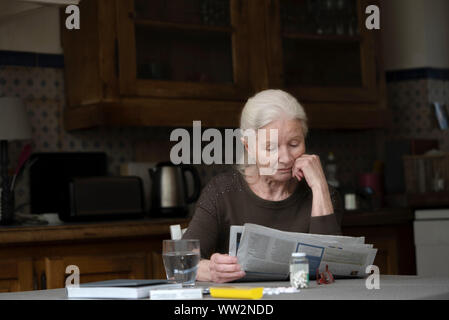 Senior woman reading newspaper Stock Photo