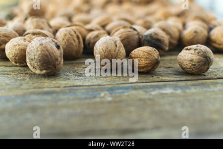 Fresh walnuts on wooden table with place for text. Stock Photo