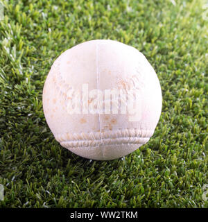 White baseball over synthetic grass, square image Stock Photo
