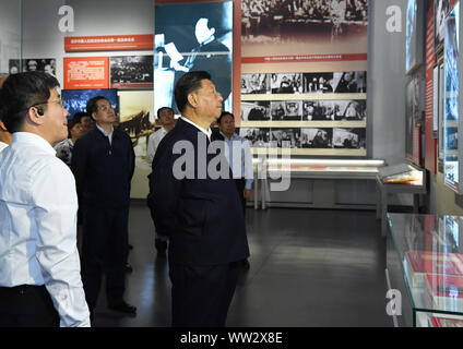 (190912) -- BEIJING, Sept. 12, 2019 (Xinhua) -- Chinese President Xi Jinping, also general secretary of the Communist Party of China (CPC) Central Committee and chairman of the Central Military Commission, visits an exhibition on the history of the CPC Central Committee, watching documentaries and reliving the history of how the CPC Central Committee moved into Beijing in 1949, at a revolutionary memorial museum in the Fragrant Hills in Beijing, capital of China, Sept. 12, 2019. Xi visited a revolutionary memorial site in the Fragrant Hills in suburban Beijing on Thursday. (Xinhua/Rao Aimin) Stock Photo