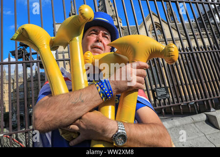 Westminster, London, 12th Sep 2019. In reference to the newly published Operation Yellowhammer Brexit preparation documents, Anti-Brexit protester Steven Bray poses with several yellow hammers outside Parliament. Credit: Imageplotter/Alamy Live News