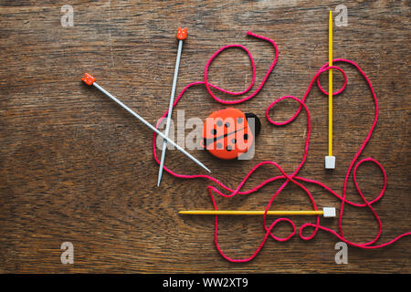Knitting needles, wool and accessories in a flat lay close up photo Stock Photo