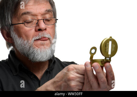 Old man is aiming with compass Stock Photo