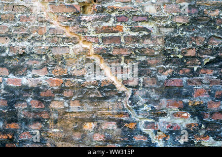 Old, damaged by time, stone wall. Natural background for designers. Stock Photo