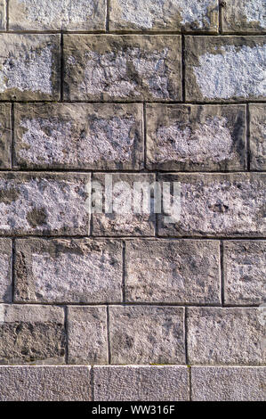Old, damaged by time, stone wall. Natural background for designers. Stock Photo