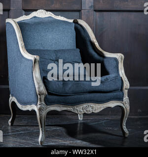 Blue classical style Armchair sofa couch in vintage room. Stock Photo