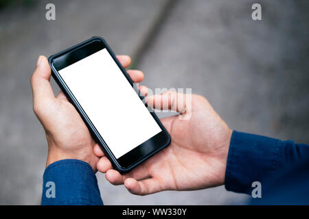 Close up of man hand holding smart phone. Blank screen mockup for graphics display montage. Stock Photo