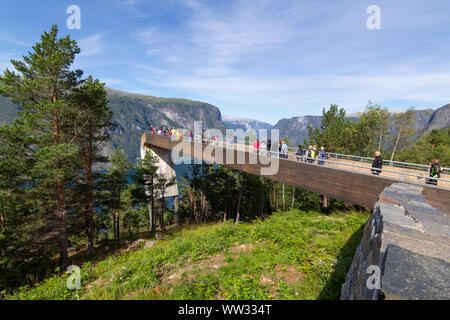 People looking at Aurlandsfjord from the top of Stegastein viewpoint platform, a modern architecture lookout with maje Stock Photo