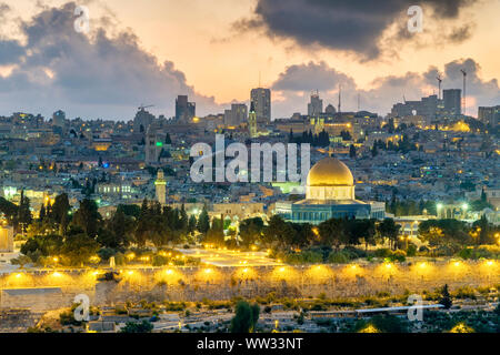 Israel, Jerusalem District, Jerusalem. Jerusalem skyline, Dome of the Rock on Temple Mount, and buildings in the Old City at dusk. Stock Photo