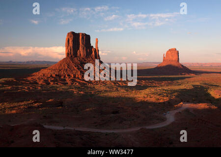 Sunset light hits the iconic rock formations in Monument Valley, AZ Stock Photo