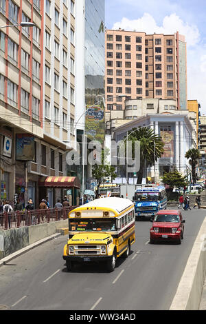 LA PAZ, BOLIVIA - NOVEMBER 28, 2014: Old Chevrolet buses used for public transport and a new Jeep on Villazon Avenue with the Plaza del Estudiante Stock Photo