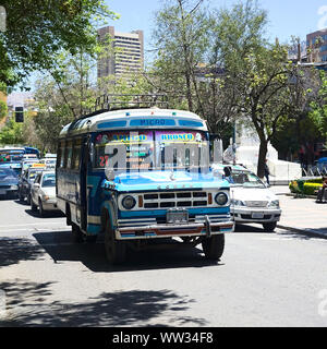 LA PAZ, BOLIVIA - OCTOBER 15, 2014: An old blue Dodge D400 bus used for public transportation driving on El Prado avenue in the city center Stock Photo