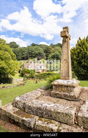 Victorian Celtic churchyard cross on a medieval base in the churchyard of St Michaels church in the Cotswold village of Buckland, Gloucestershire UK Stock Photo