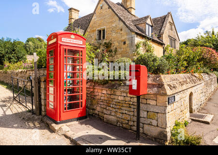 An old red telephone box now converted into an information point on the Cotswold Way in the Cotswold village of Stanton, Gloucestershire UK