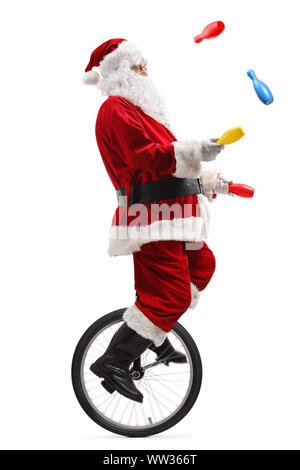 Elderly man a riding a unicycle and juggling isolated on white ...