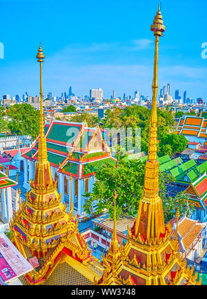 BANGKOK, THAILAND - APRIL 24, 2019: The unique golden spires of Loha Prasat shrine of Wat Ratchanatdaram complex decorated with small umbressla on the Stock Photo