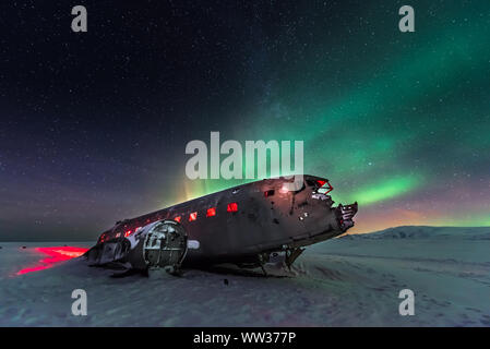 Northern lights over plane wreckage in Iceland Stock Photo
