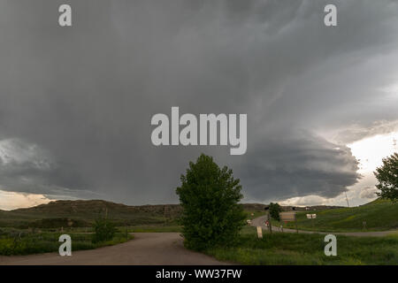 Severe supercell thunderstorm with large wall cloud and hail core moves over the rolling high plains of northeastern Wyoming, USA Stock Photo