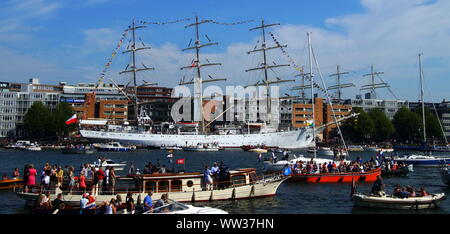 Amsterdam, the Netherlands - August 22, 2015: Polish tall ship Dar Mlodziezy docked during Sail 2015 in harbor of Amsterdam. Stock Photo