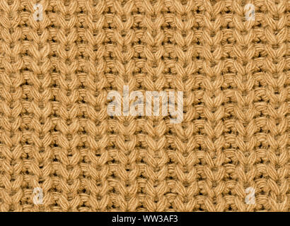 Knitted fabric texture in autumn color. Close-up. Abstract background. Stock Photo