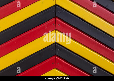 Colours of the German national flag painted on a wooden shed Stock Photo