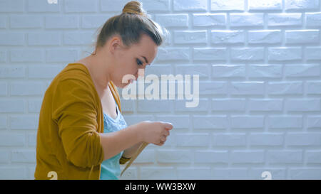 Professional woman decorator, designer making envelope at workshop Stock Photo