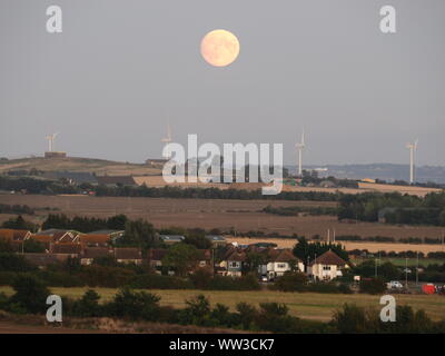 Halfway Houses, Sheerness, Kent, UK. 12th September, 2019. UK Weather: the 98% waxing gibbous moon rising over farmland on the Isle of Sheppey in Kent as seen from Halway Houses, Sheerness. Tomorrow will see a full moon - the first on Friday 13th for a number of years. The September full moon is known as the Harvest Moon. Credit: James Bell/Alamy Live News Stock Photo