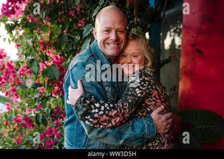 Happy dad and daughter with Down Syndrome hugging Stock Photo