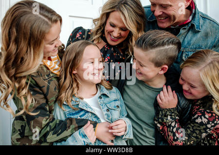 Happy family smiling at preteen girl Stock Photo