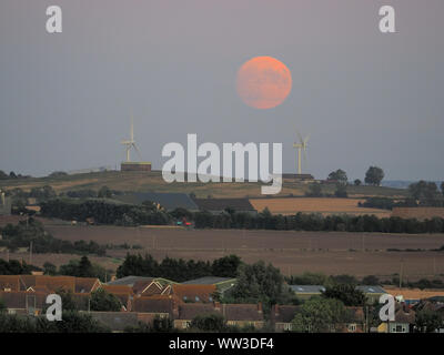 Halfway Houses, Sheerness, Kent, UK. 12th September, 2019. UK Weather: the 98% waxing gibbous moon rising over farmland on the Isle of Sheppey in Kent as seen from Halway Houses, Sheerness. Tomorrow will see a full moon - the first on Friday 13th for a number of years. The September full moon is known as the Harvest Moon. Credit: James Bell/Alamy Live News Stock Photo