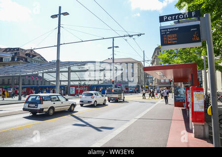 Bern, Switzerland - August 14, 2019: Bus station by the main train station in the center of the Swiss capital. Public transport. People on the street. Cars on the road. Intersection. Daily life. Stock Photo