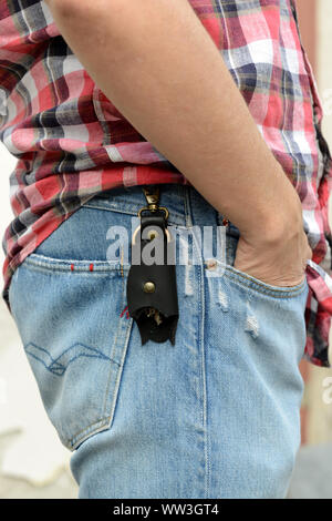 Leather keychain in Bat shape and keys hooked on pants. - image Stock Photo