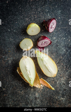 Halved fresh bulbs on old kitchen table. Top view. Stock Photo
